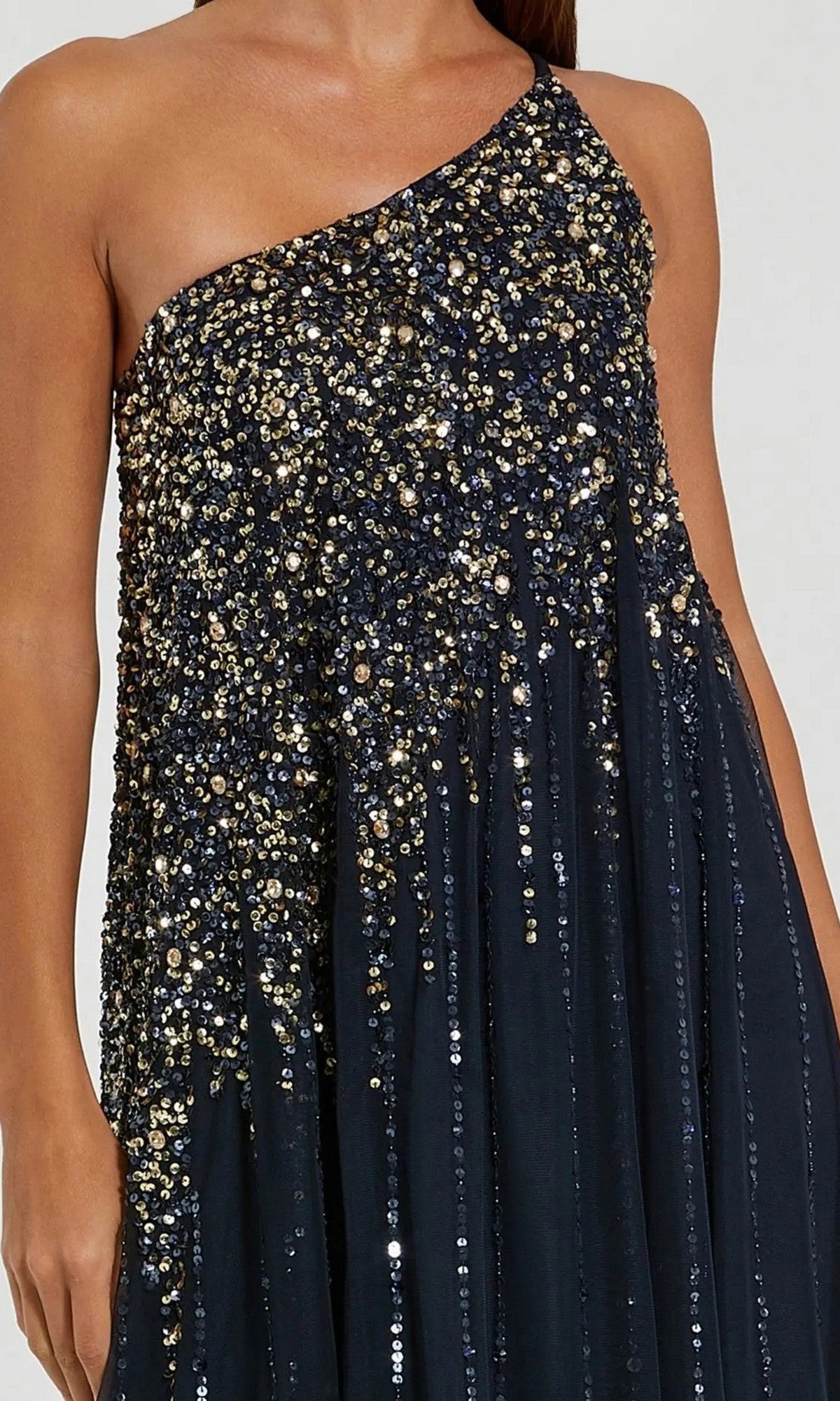 Wearing the Mac Duggal 9224 One-Shoulder Long Formal Dress in navy blue, featuring gold and silver sequins on the bodice and upper skirt, creates a stunning formal look.